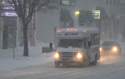 Metro Mobility drivers and passengers make essential trips in all kinds of weather. A Metro Mobility vehicle driving during a snowstorm.