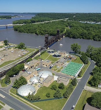 Our wastewater treatment plant in Hastings has 30 consecutive years of perfect compliance with clean water discharge permits, among the best records in the nation. Overhead view of a wastewater treatment plant next to a river.