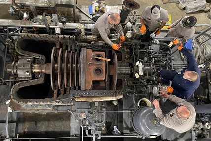 Overhead photo of five people standing around the existing G7 steam turbine