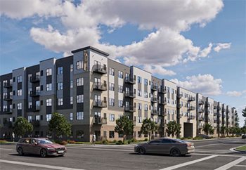 Large five-story apartment building at the intersection of two streets.